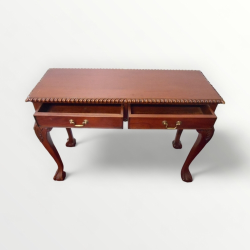 214 - Mahogany finished two drawer side table with fancy carved edges on tall slender legs with 'ball and ... 