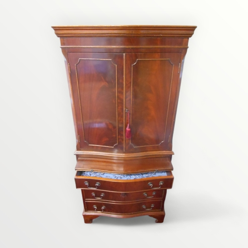 253 - Reproduction mahogany finished serpentine fronted 'drinks' cupboard having a 'prep slide' over a sin... 