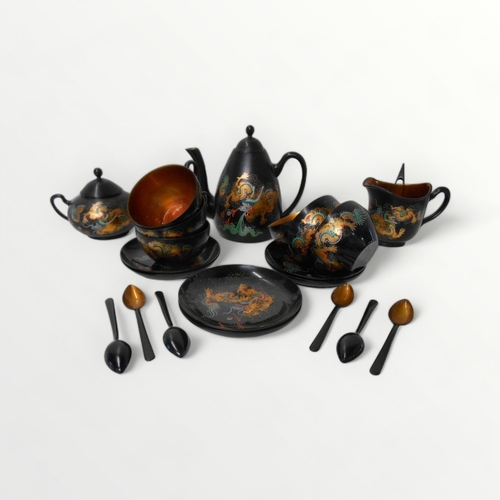 249 - Oriental lacquer tea service for six (complete) decorated with a dragon chasing a flaming pearl, the... 