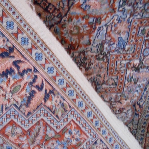 274 - Fine woven wool/silk carpet with floral central medallion on a busy field within multiple guard bord... 