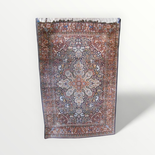 278 - A fine woven silk 'book cover' floor rug 118 x 185cm.