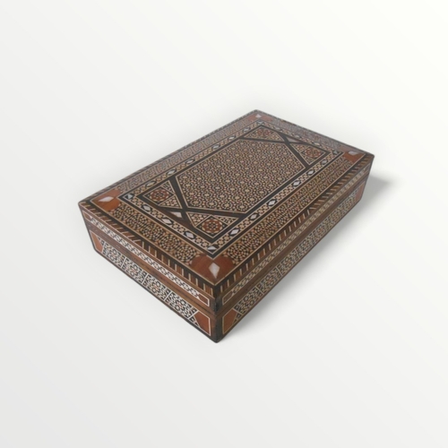 282 - Decoratively inlaid wooden box probably Indian,6 x 23 x 15cm. Shipping group (A).