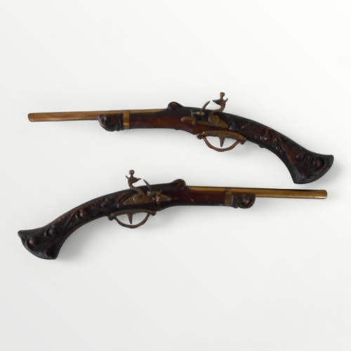 294 - A pair of reproduction wall hanging flintlock pistols, 51cm long. Shipping group (A).