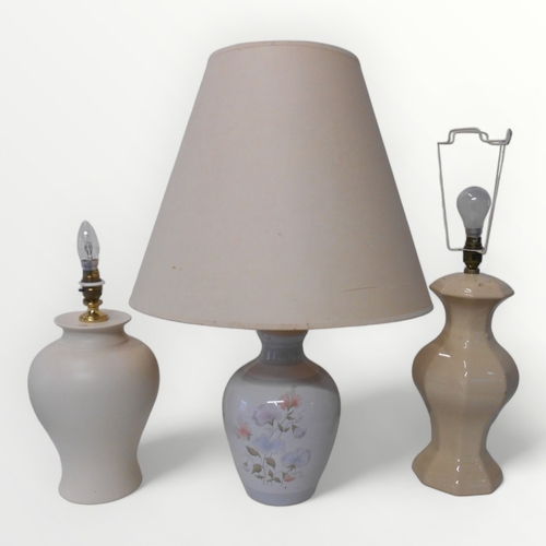 301 - Three pottery based table lamps.