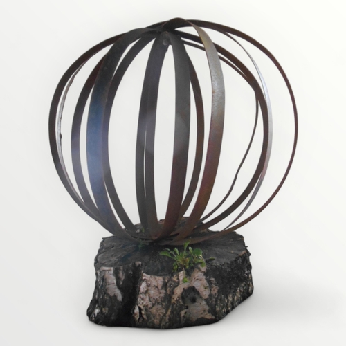 306 - A large decorative garden sphere made from iron straps 86cm high mounted on a 'silver birch' slice.