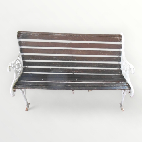 307 - A part slatted garden bench with white painted cast iron ends. 77 x 126cm.