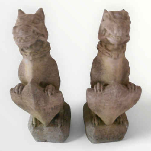 314 - Two large cast concrete 'Guardian Gargoyles' each seated on a plinth base and holding shields. 77cm ... 