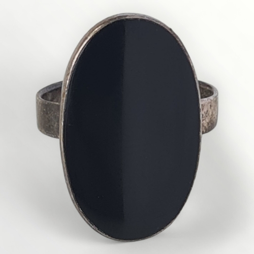 39 - Silver and large black stone set ring. Size L. Shipping group (A).