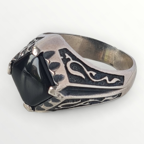 4 - A mens silver gothic style black onyx signet ring, size V. Shipping group (A).