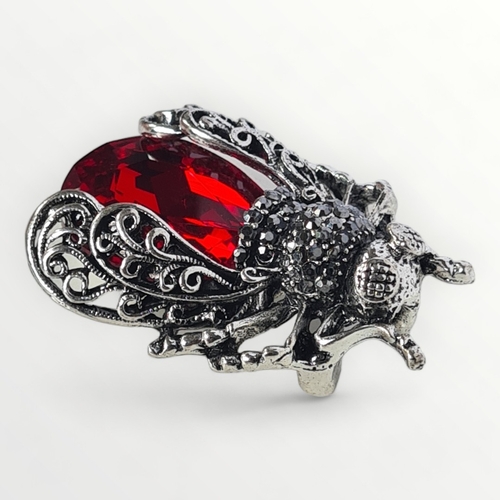 6 - A large silver and red coloured stone set bug brooch, approx 4cm. Shipping group (A).