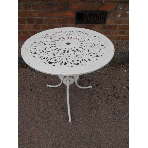 324 - White painted cast metal outdoor table.