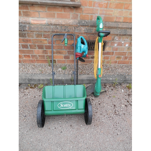 325 - Lawn seeder, 240v electric hedge trimmer, and a strimmer.