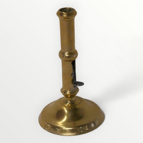 103 - An eighteenth century George II brass side ejector single candlestick c.1760, being 18cm tall. Shipp... 