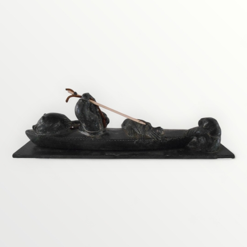 112 - Hand carved 'Inuit' stone sculpture of a hunting fisherman in his kayak. 33cm long. Shipping group (... 