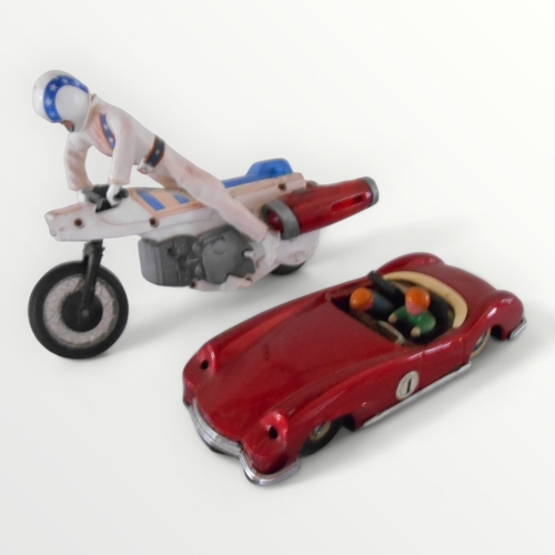 116 - 'Evil Knievel' stunt rider figure and a modern tin plate sports car, 22cm long. Shipping group (A).