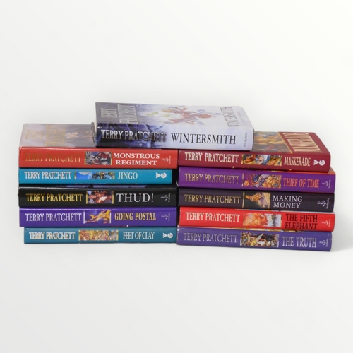 126 - Eleven hardback Terry Pratchett 'Discworld' novels.