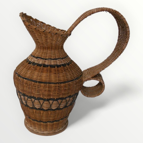 157 - Decorative woven rattan oversized jug, 49cm high.