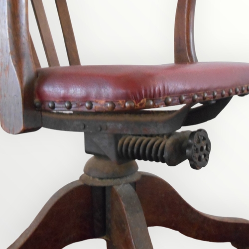 217 - 1930's English oak framed desk chair having horse shoe back with a pad seat on a sprung column and f... 