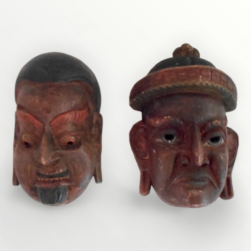 105A - Two Eastern carved wood wall masks, 31cm longest. Shipping group (A).