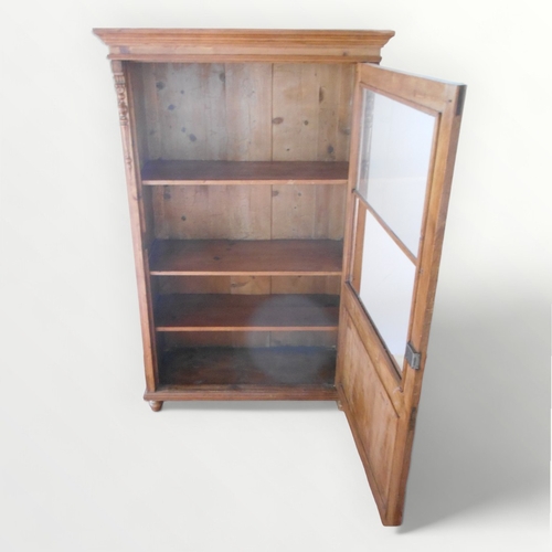 234 - Victorian pine cupboard having part glazed single door and a shelved interior, standing on four shor... 