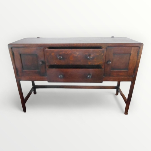 266 - 'Cotswold School' oak sideboard having two central drawers flanked by two cupboard doors each having... 