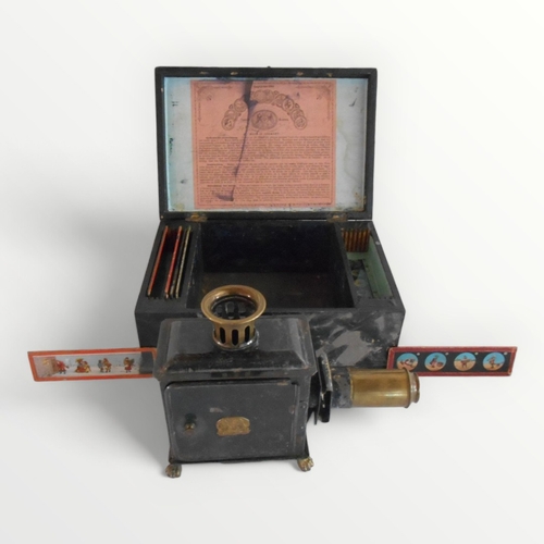 296 - Antique boxed German made 'Magic Lantern' of small proportions retaining some original slides, it st... 