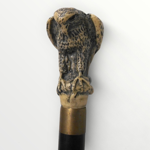 318 - Modern walking stick with cast 'bird of prey' handle, unscrewing to reveal a glass phial with cork s... 