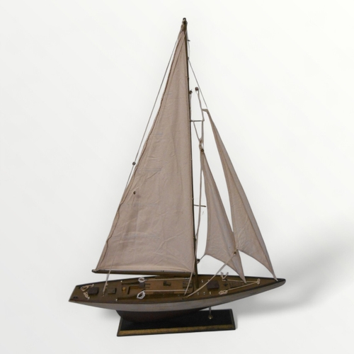 320A - Well made model yacht on plinth stand, 75 x 100cm.