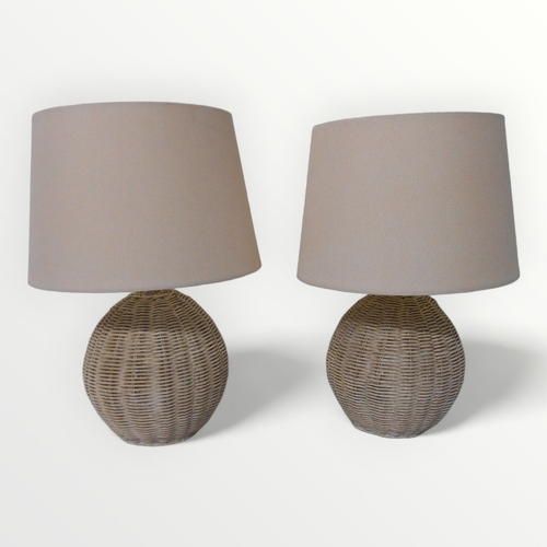 321 - Two woven rattan globular based table lamps with shades. 38cm inclusive.