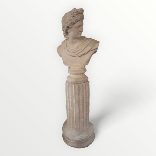 348 - A large and imposing plaster decorative portrait bust of 'Apollo' on a plain socle standing on a dis... 