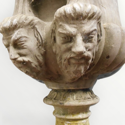 351 - A well cast large classical garden urn planter having grape and vine band over twin mask 'handles' o... 