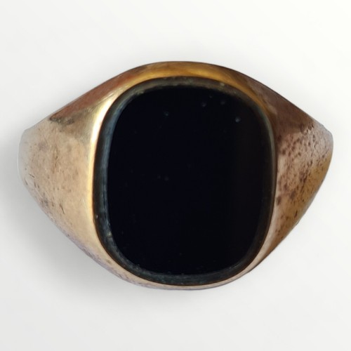 2 - 9ct gold and black stone set signet ring, size V. Shipping group (A).