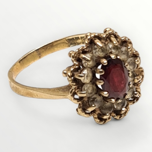 44 - 9ct yellow gold garnet and clear stone halo ring, hallmark for Birmingham 1973. Size O. 3g. Shipping... 