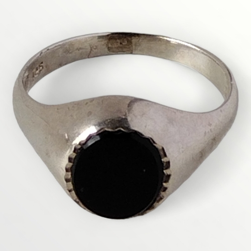 65 - .925 silver and black stone set signet ring, size V. Shipping group (A).