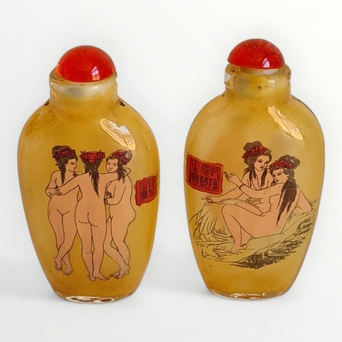 184 - Two Oriental glass snuff bottles painted with 'erotic' scenes, 7.5cm high, including spoon/stopper. ... 