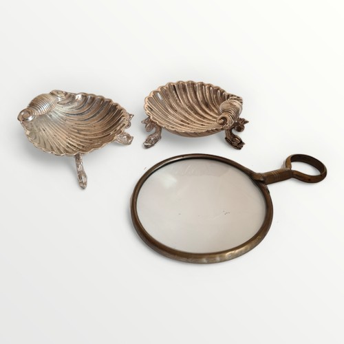 7 - Pair of scalloped salts and a vintage magnifying glass. Shipping group (A).