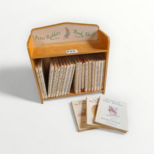 245 - 'Peter Rabbit's Book shelf' being 23 stories by Beatrix Potter housed in a wooden box,29cm high, and... 