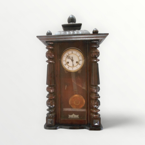 113 - Traditional Viennese hanging wall clock having gong strike, pendulum and key. 74cm.