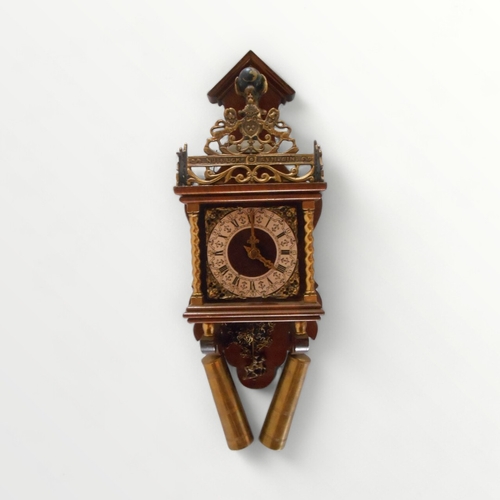 114 - Reproduction Dutch design hanging wall clock having applied cast brass decoration. A bell strike, pe... 