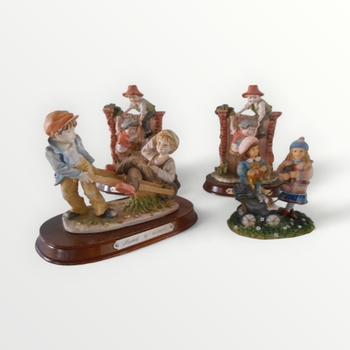 116 - Four cast 'Leonardo' figural children's groups, some on wooden plinths. 19.5cm tallest. Shipping gro... 