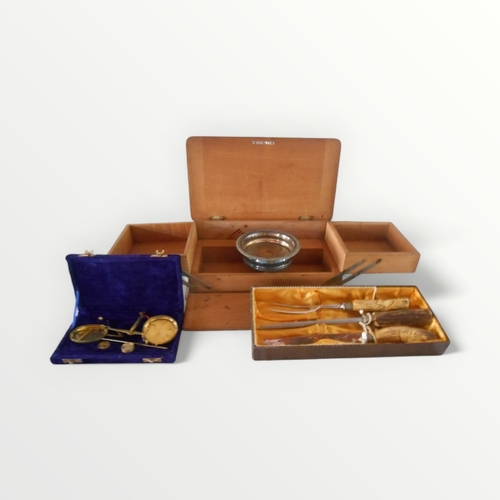 125 - Cantilever wooden box, carving set, wine bottle coaster and a cased set of brass scales. Shipping gr... 