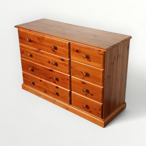 149 - Modern pine double width chest of eight drawers. 81 x 118 x 44cm.