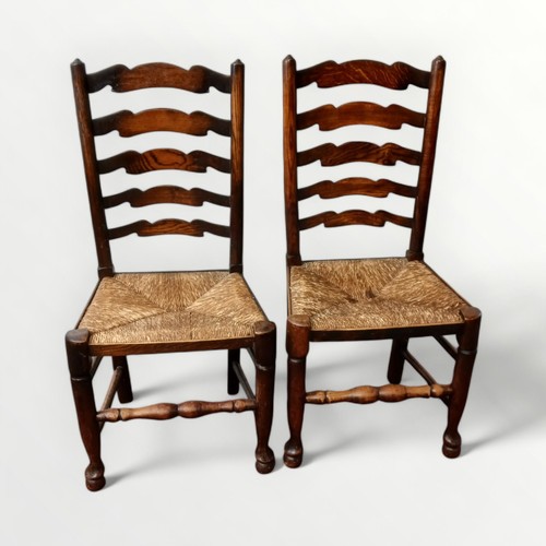 153 - Seven 19th century country ladder back chairs with rush seats (two photographed), comprising six sin... 