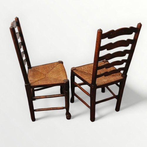 153 - Seven 19th century country ladder back chairs with rush seats (two photographed), comprising six sin... 