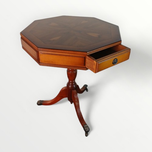 161 - A reproduction yew wood octagonal small table with twin opposing drawers turned column and tri-pod b... 