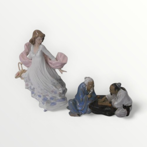 260 - Lladro porcelain female figure 30cm tall, together with a Chinese figure group. Shipping group (A).