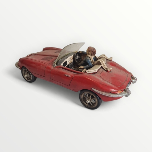 277 - Model Jaguar E-Type motorcar with hipster driver, 45cm long. Shipping group (A).