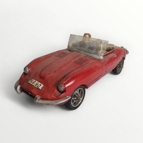 277 - Model Jaguar E-Type motorcar with hipster driver, 45cm long. Shipping group (A).