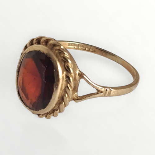 20 - 9ct gold single garnet ring. Shipping group (A).