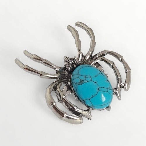 24 - White metal and blue stone set spider brooch. Shipping group (A).